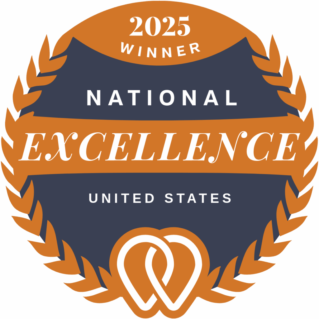 Circular badge labeled "2025 Winner, National Excellence, United States," featuring laurel wreath design and an interlocking heart emblem.