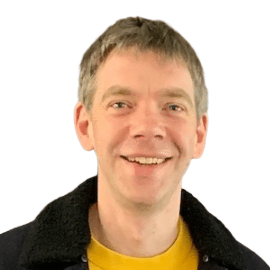 A person with short hair and a yellow shirt smiles in a close-up portrait against a plain white background.
